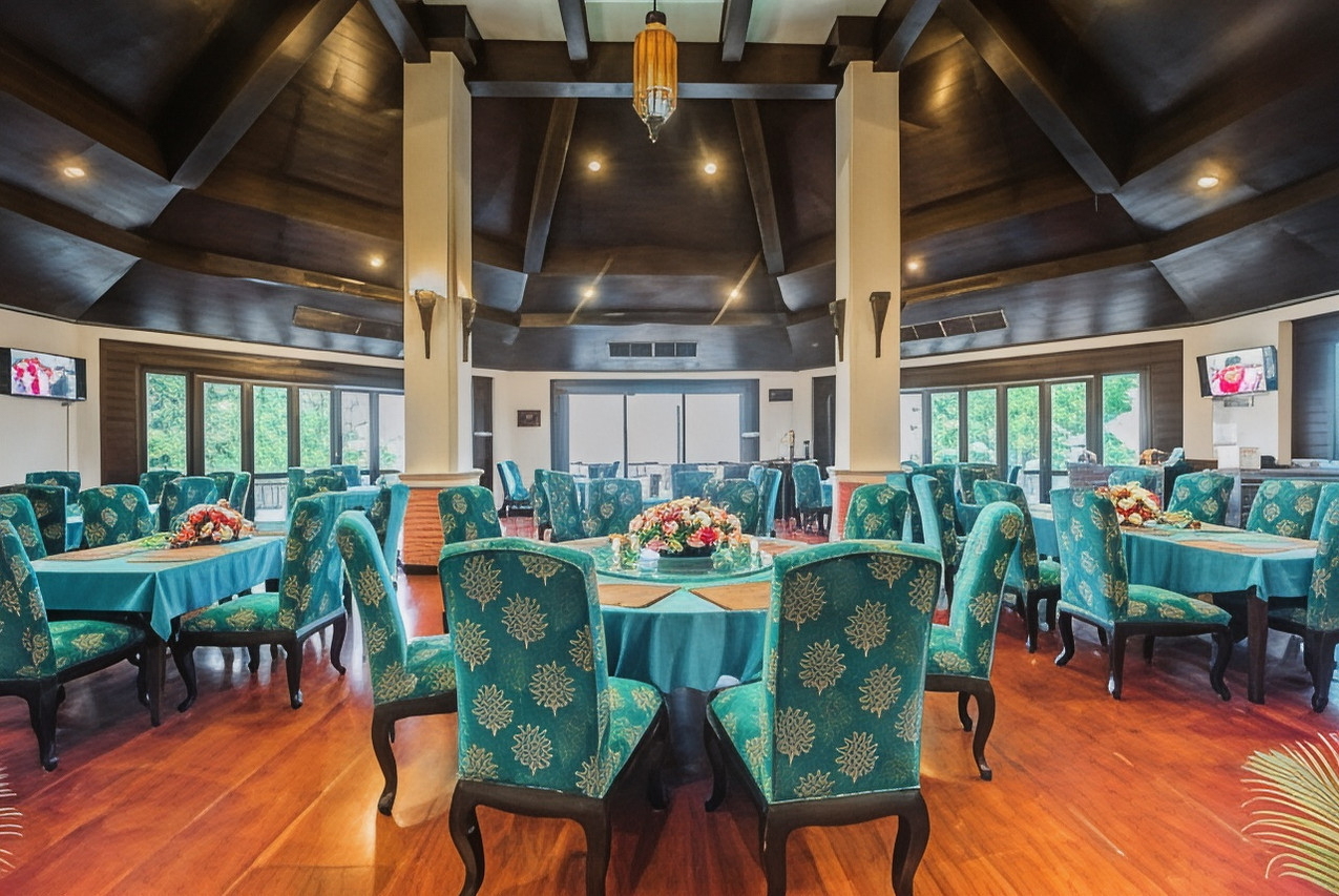 Resort restaurant with Lanna-style timber ceiling and green chairs