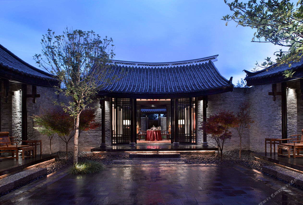 Banyan Tree Lijiang (丽江悦榕庄) — the view from a villa balcony over the Naxi-style tile roofs to the peak of Jade Dragon Snow Mountain