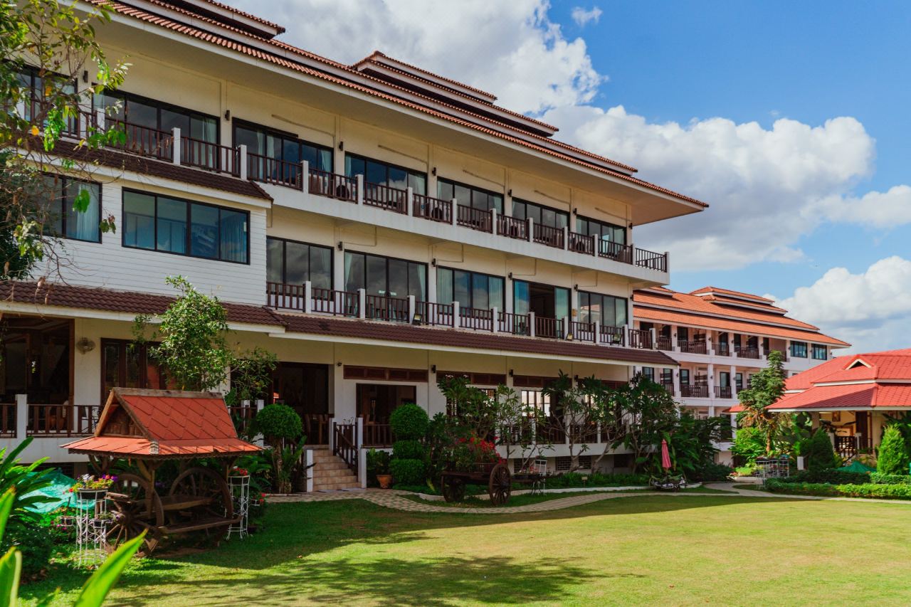 Thai-roofed guest building with balconies and lawn