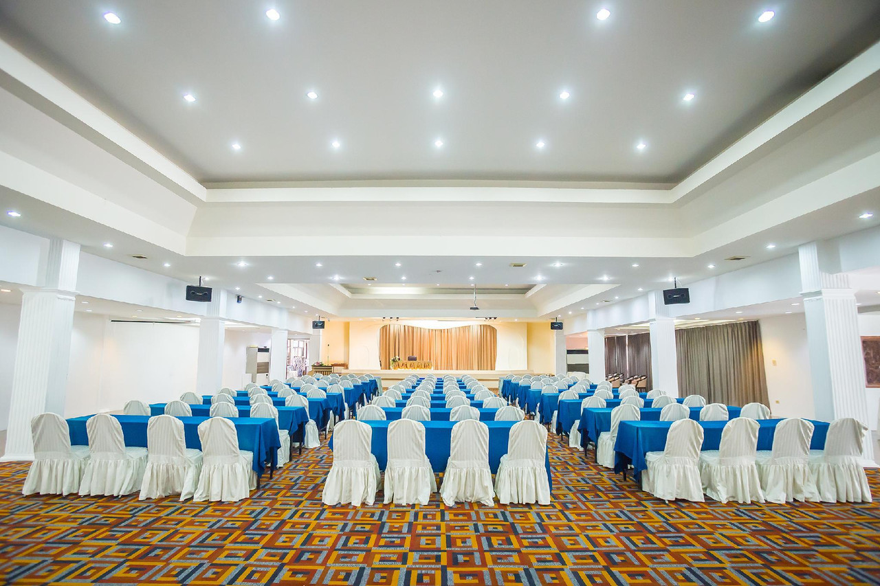 Large banquet hall set theatre-style with blue table linen at Lopburi Inn Resort