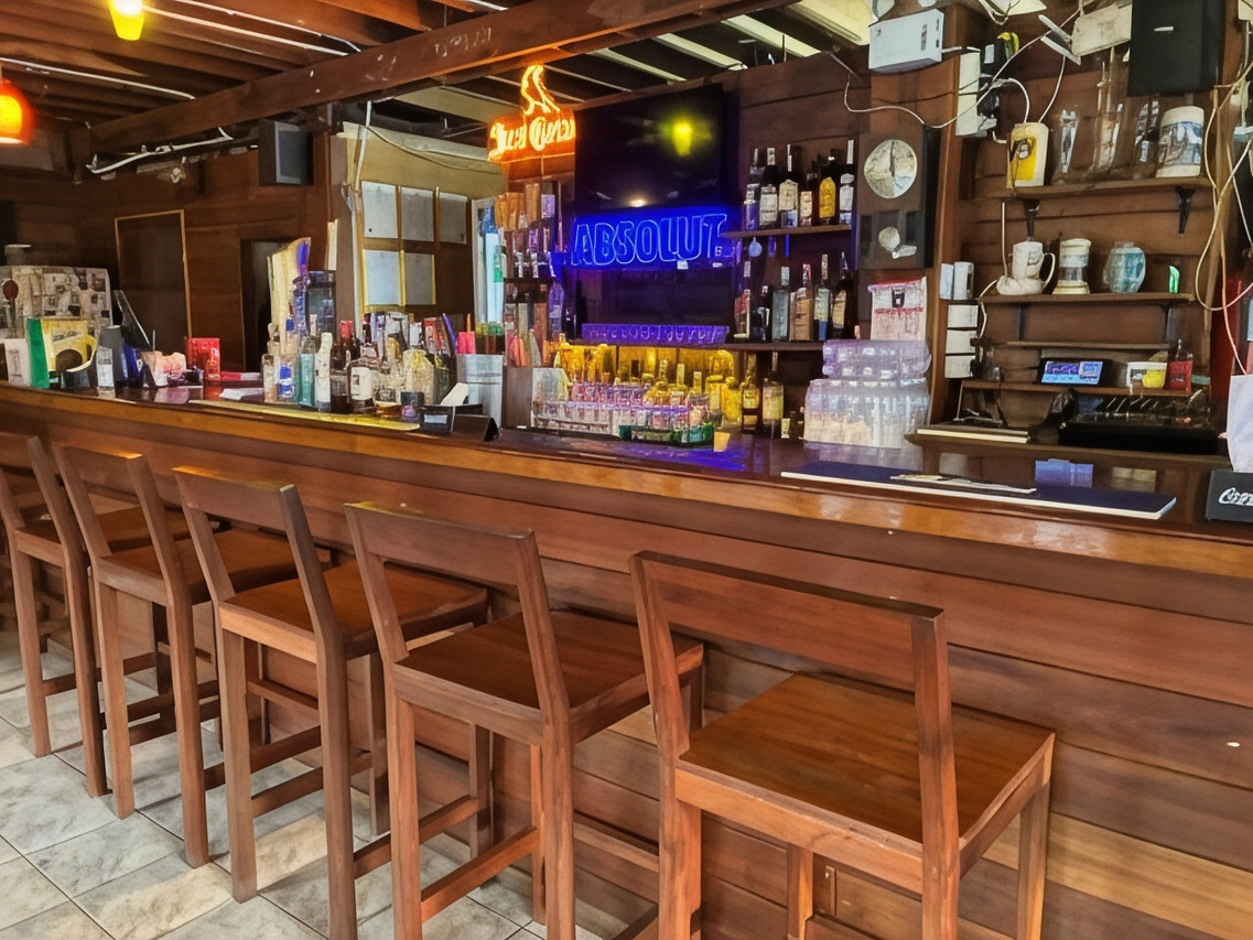 Wooden bar with high stools and a relaxed, friendly feel at Noom Guesthouse