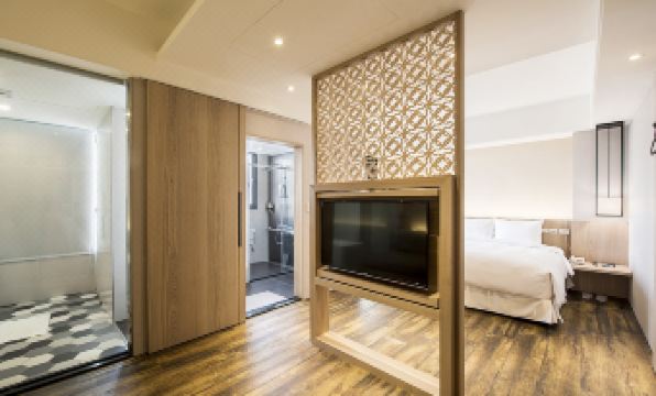 Joy Inn Lukang guest room — clean modern furnishings, comfortable bed, bright lighting