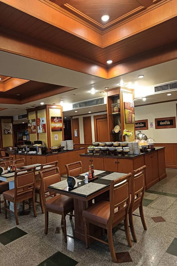 Wood-panelled restaurant with a breakfast buffet line