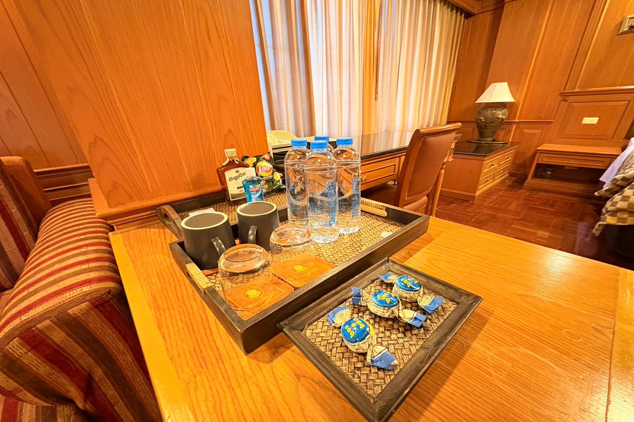Guest room corner with a wooden welcome tray of water and coffee