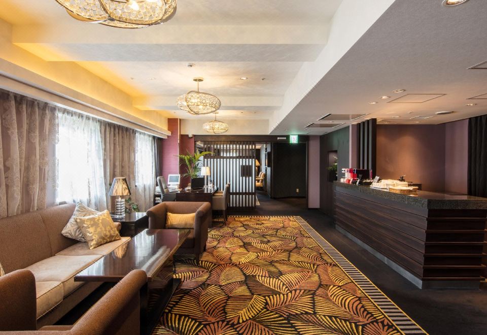 Hotel Buena Vista Matsumoto lobby and front-desk reception area with decorative leaf-pattern carpet