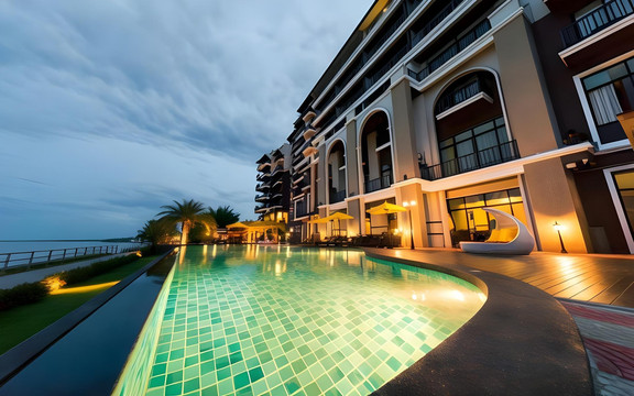 Riverside pool at Hotel de Ladda Mukdahan at dusk overlooking the Mekong