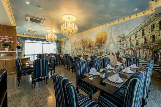 De Paris restaurant with a painted Paris streetscape mural and chandeliers