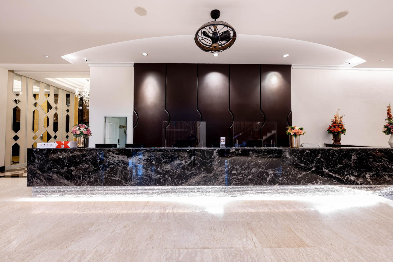 Hotel Muq lobby with black marble reception desk