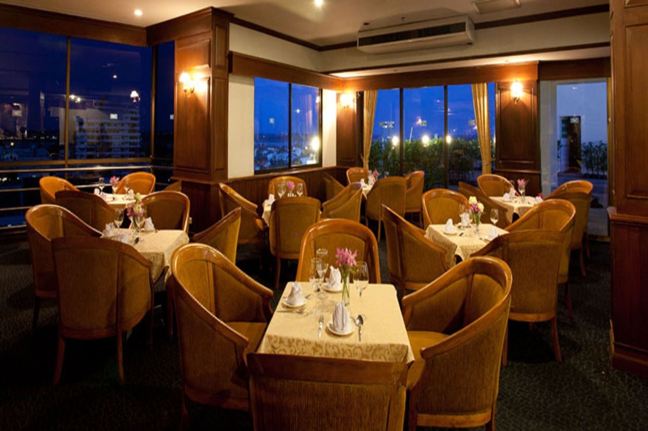 Sky Lounge restaurant on the top floor at night, city lights and Mekong River view