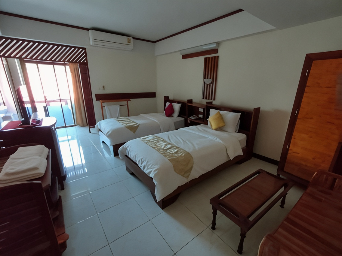 Twin room with a sliding-door balcony facing the Mekong River