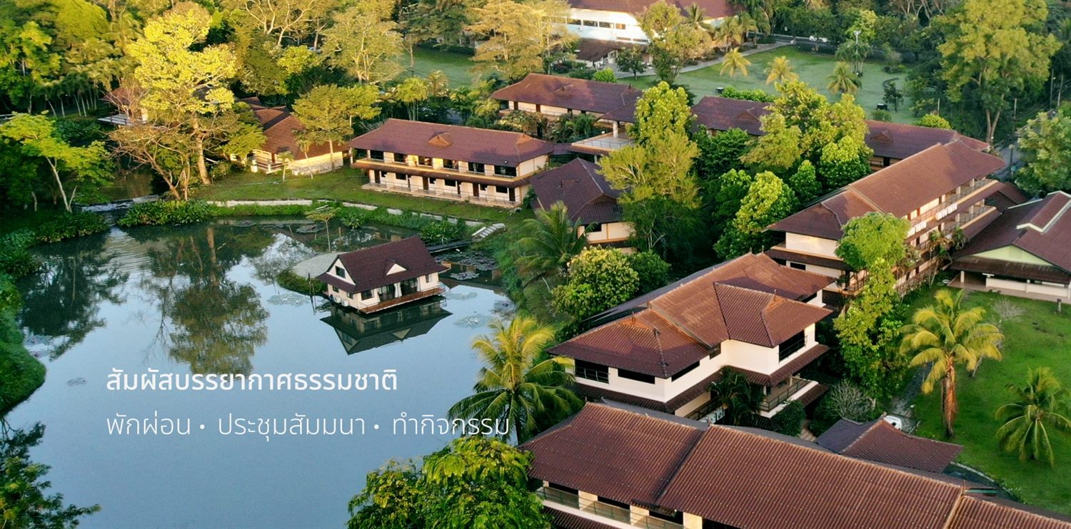 Aerial view of Wangree Resort with tiled-roof lodges lined along a lake in the forest
