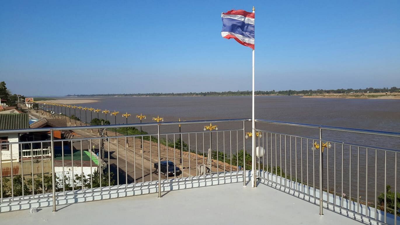 Hotel rooftop with stainless railing overlooking the Mekong and the Naga lamp posts along the embankment