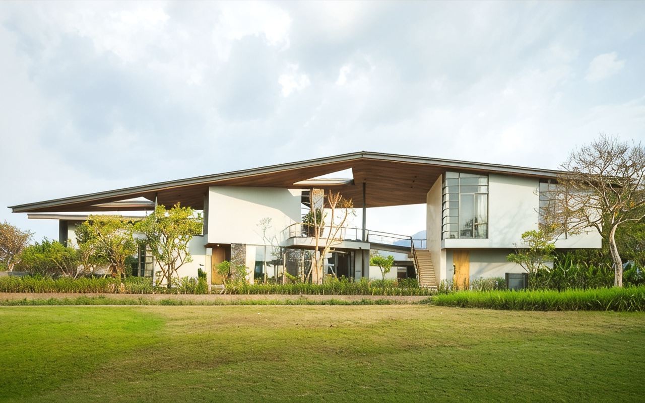 Muthi Maya lobby building with a swept butterfly roofline against the Khao Yai hills