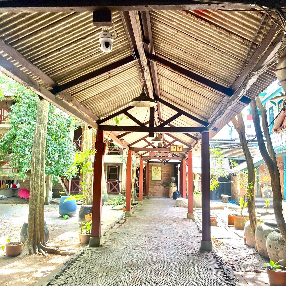 Covered garden walkway running through the leafy grounds