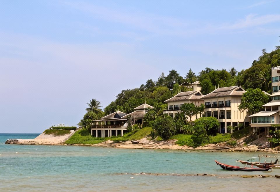 Thai-roofed guest suites stepped down the wooded headland above Nai Phlao Beach