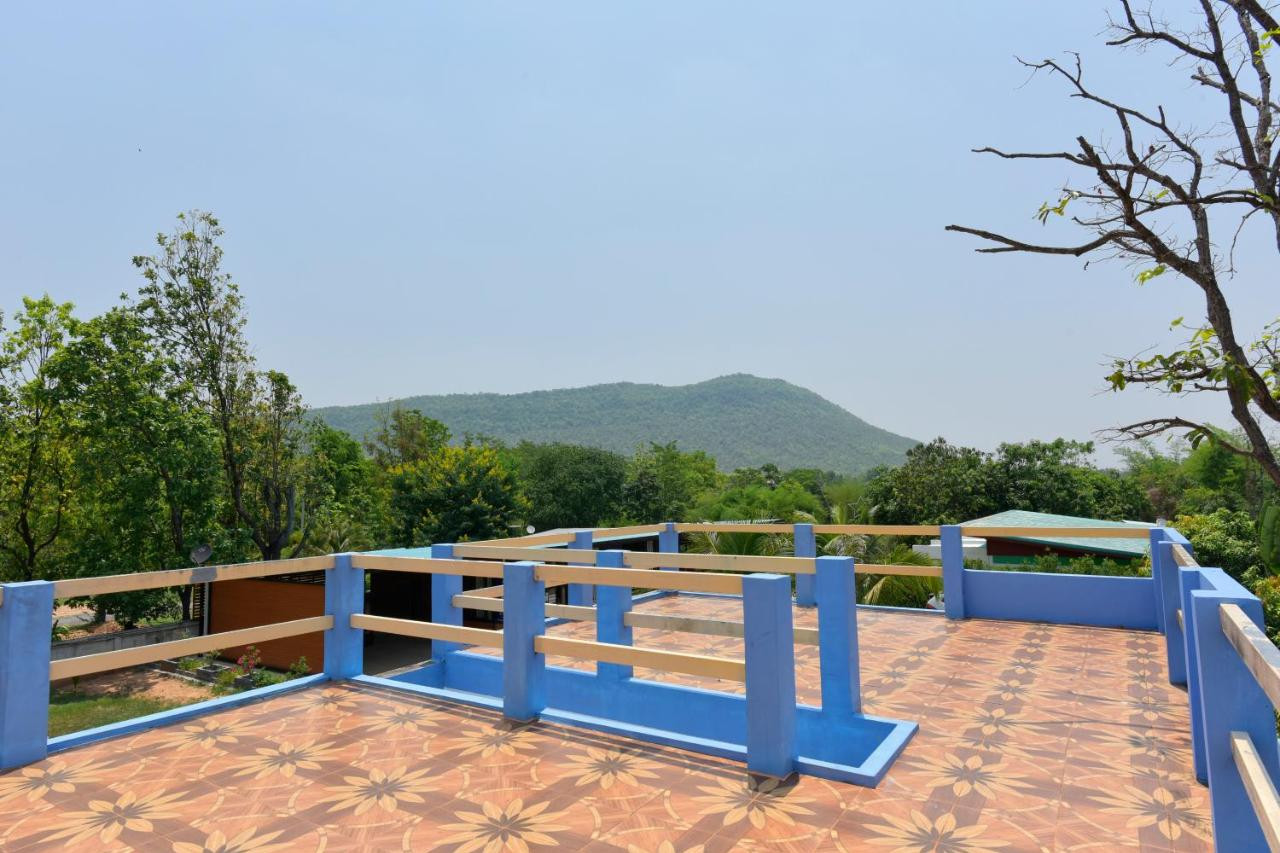 Tiled rooftop terrace at Chomduen Phu Kao Resort with the Phu Kao range behind
