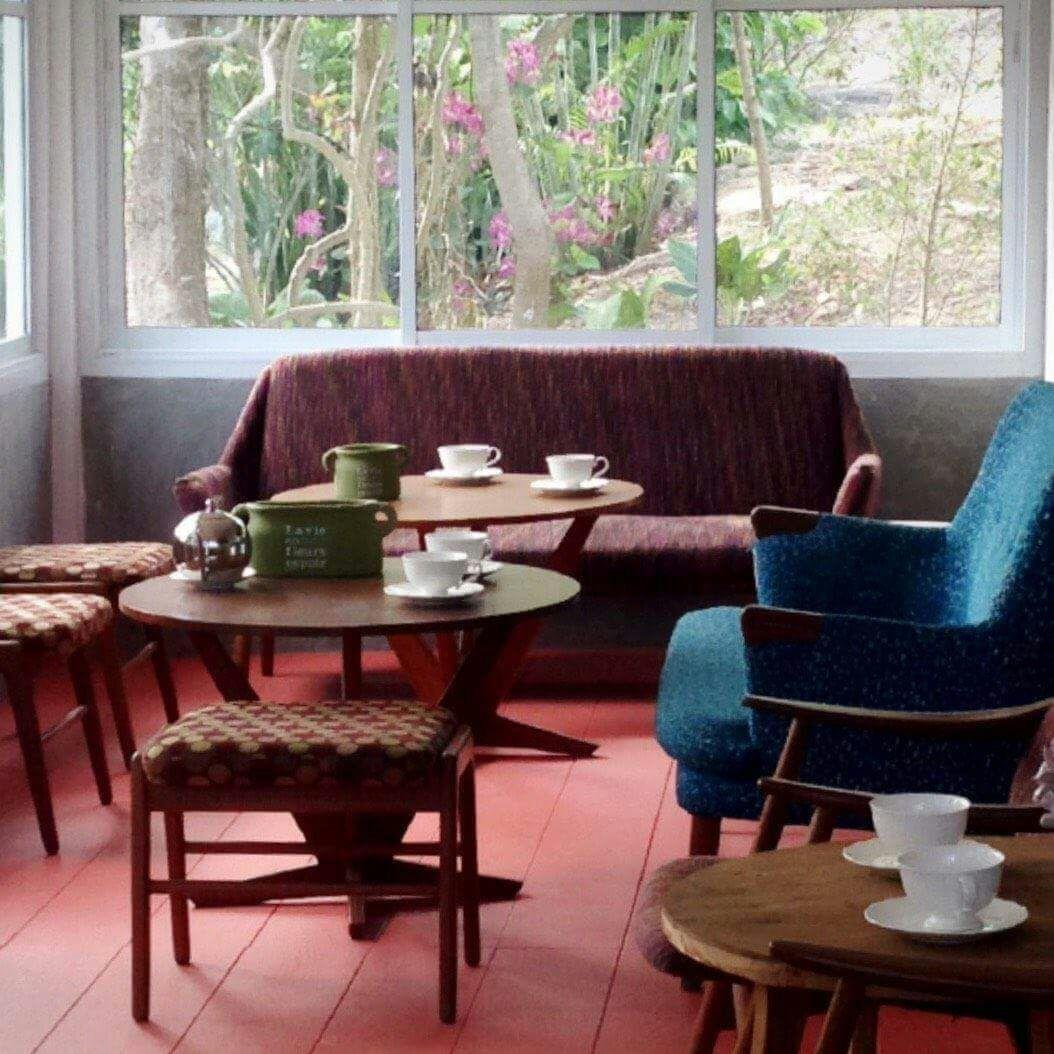 Vintage seating corner by a window looking out onto the garden