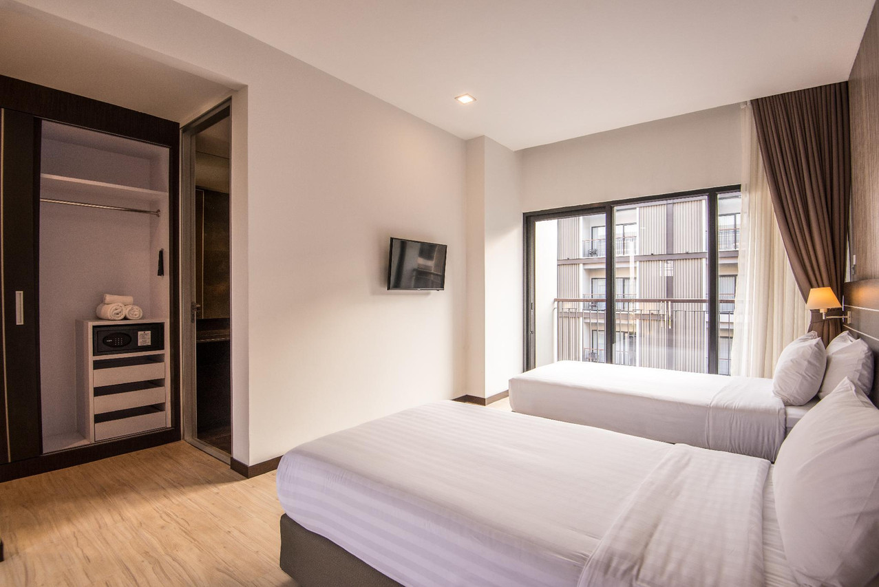Twin-bed room with a balcony facing the opposite hotel block