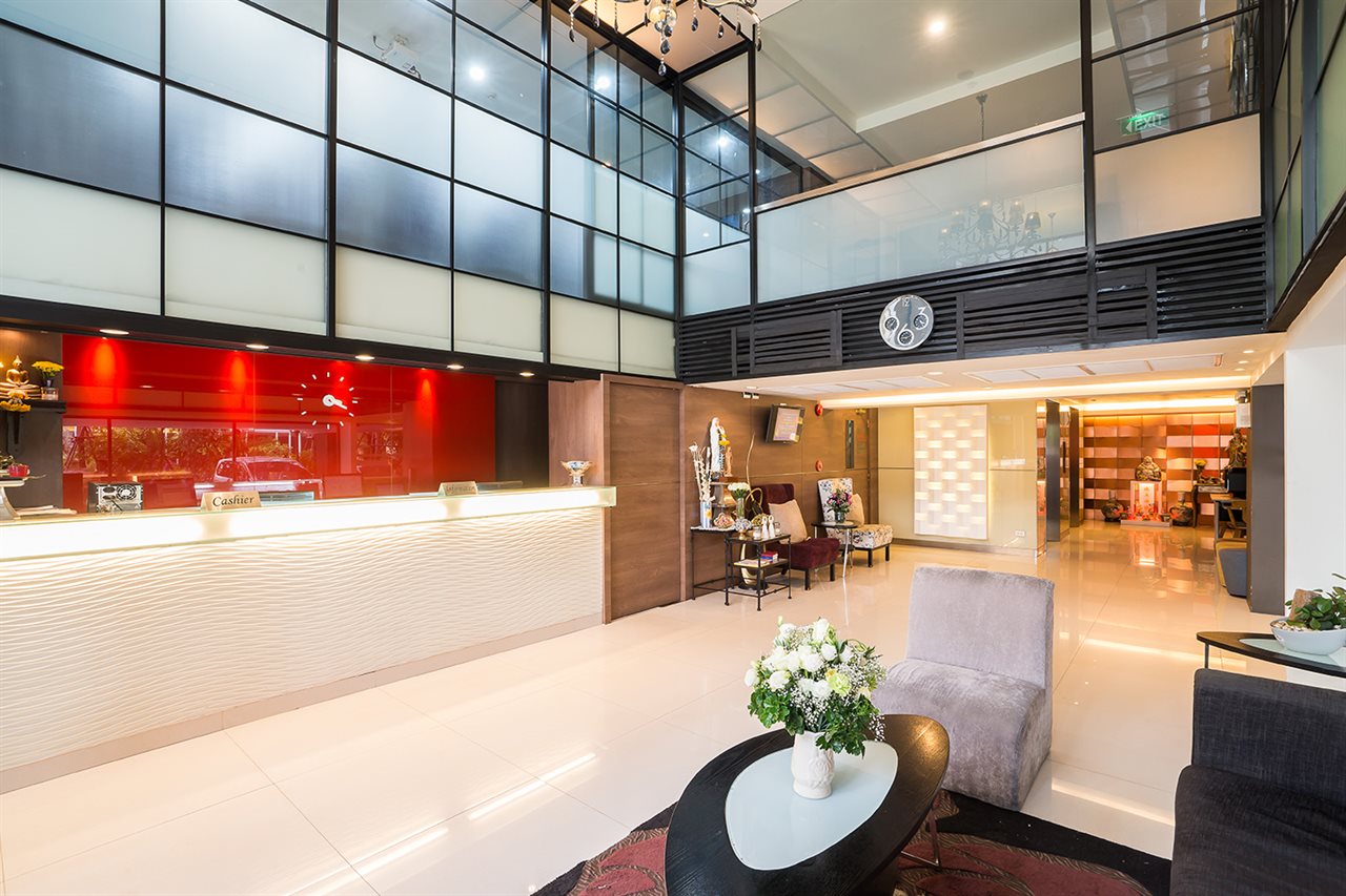 Double-height lobby and reception desk in red and white tones