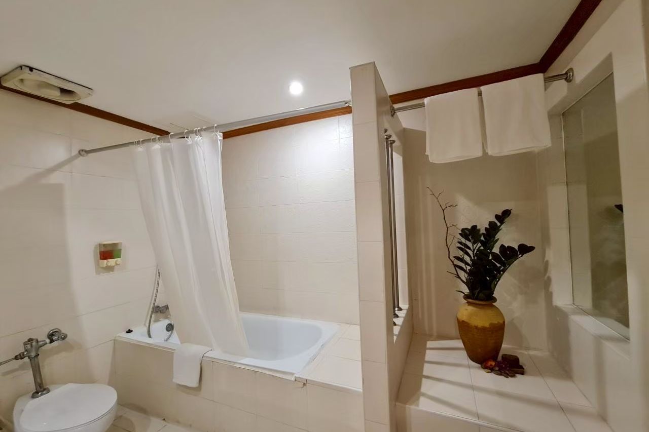In-room bathroom with a soaking tub at The Rich Hotel Nonthaburi