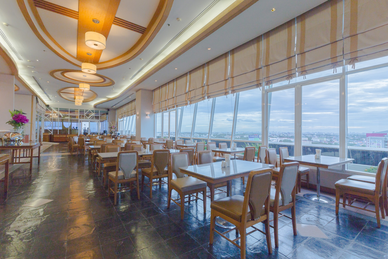 10th-floor restaurant with floor-to-ceiling windows over the Rangsit cityscape