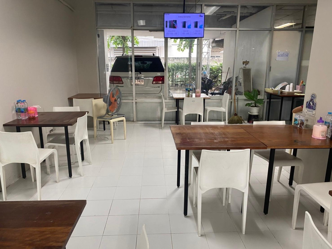 In-building café and restaurant with wooden tables and white chairs