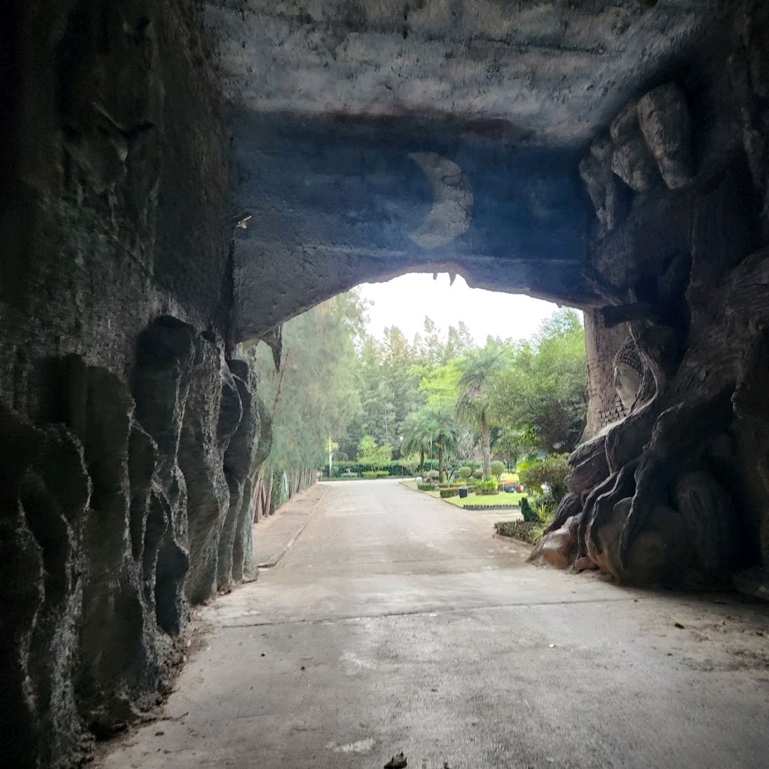 View out of the stone cave tunnel toward the landscaped grounds at The Pine Resort