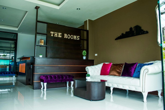 The Rooms Residence lobby with reception counter and sofa