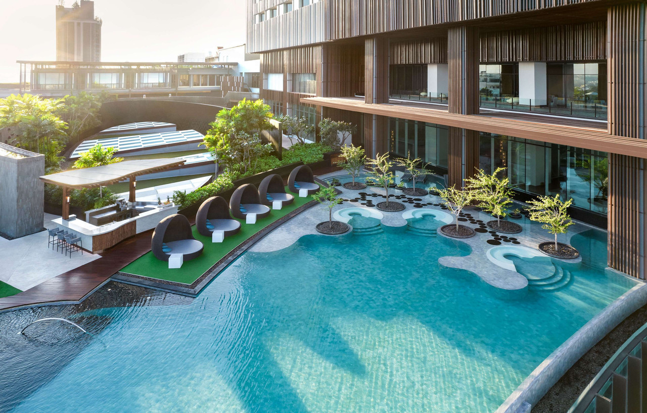 Outdoor infinity pool with sun loungers along the deck