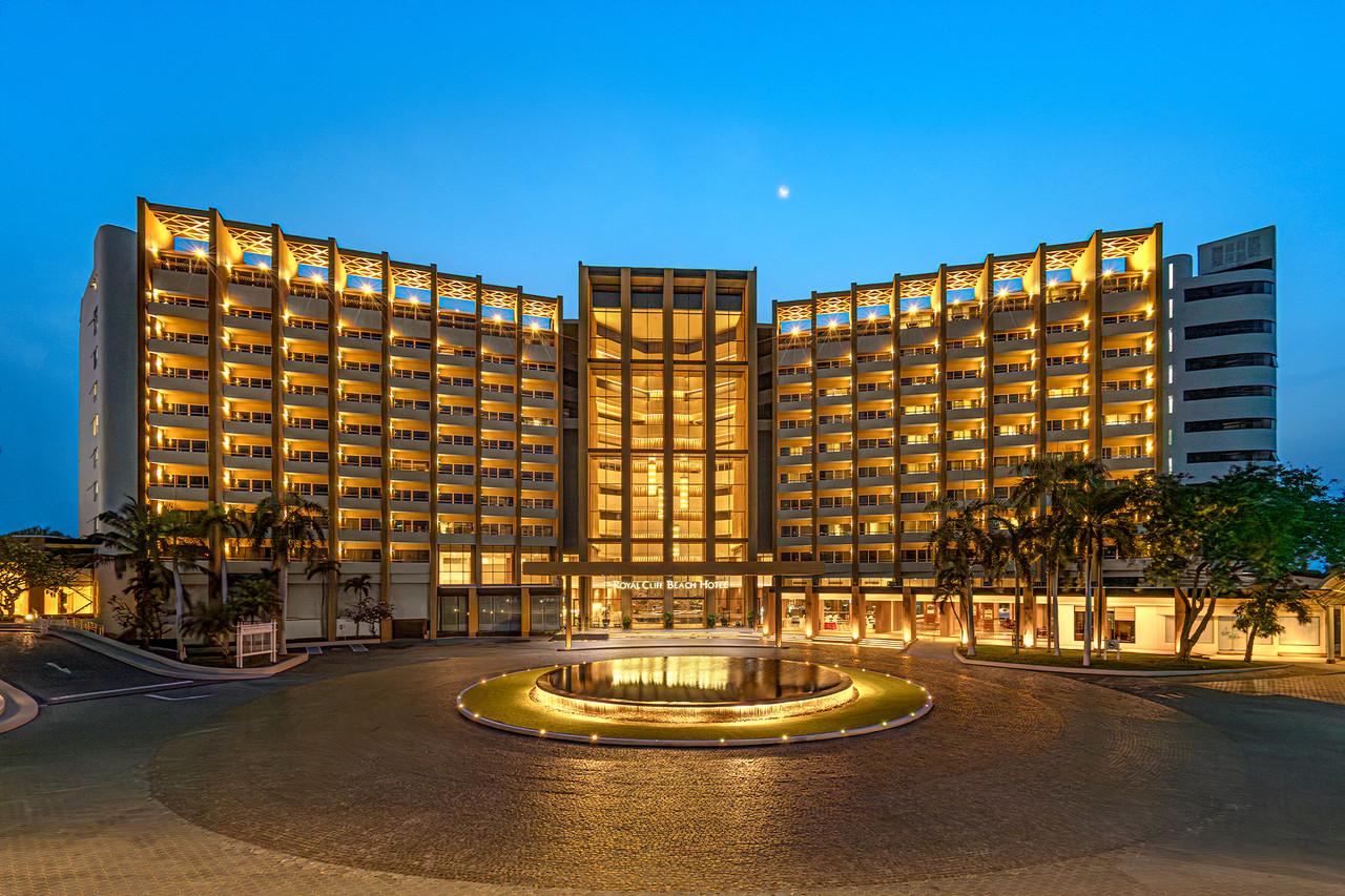 Royal Cliff Beach Hotel building at dusk with the fountain forecourt