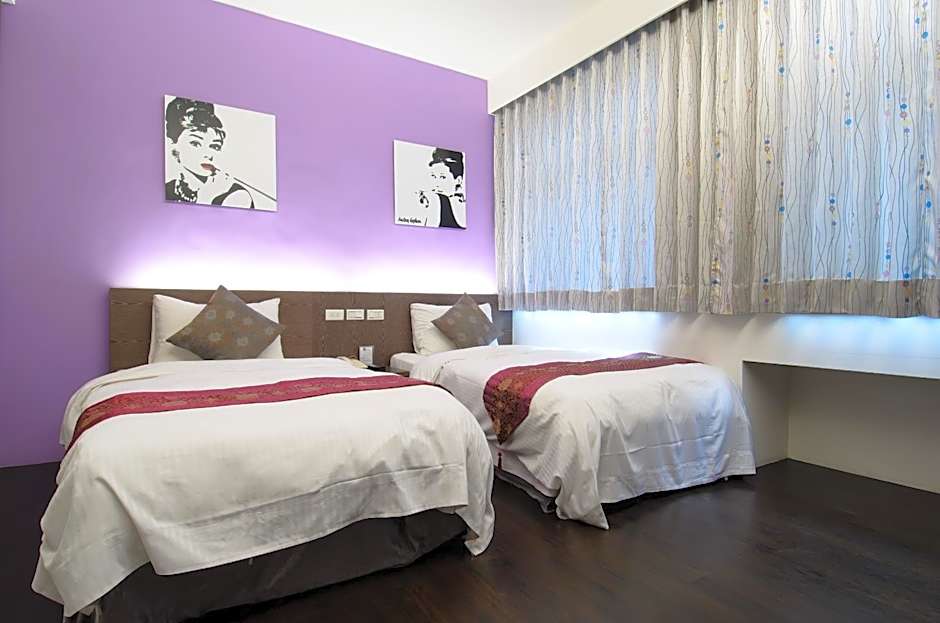 Boutique twin room with purple accent wall and Audrey Hepburn pop-art