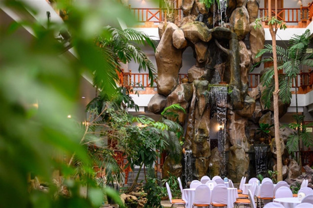 Indoor rock-waterfall atrium and garden lobby with banquet tables