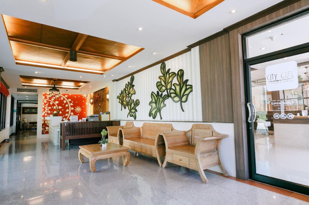 City Park Hotel Phatthalung lobby with wooden furniture and City Cafe entrance