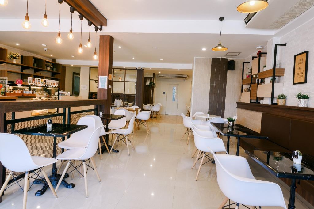 City Cafe coffee shop and bakery at City Park Hotel Phatthalung — white chairs, ground floor
