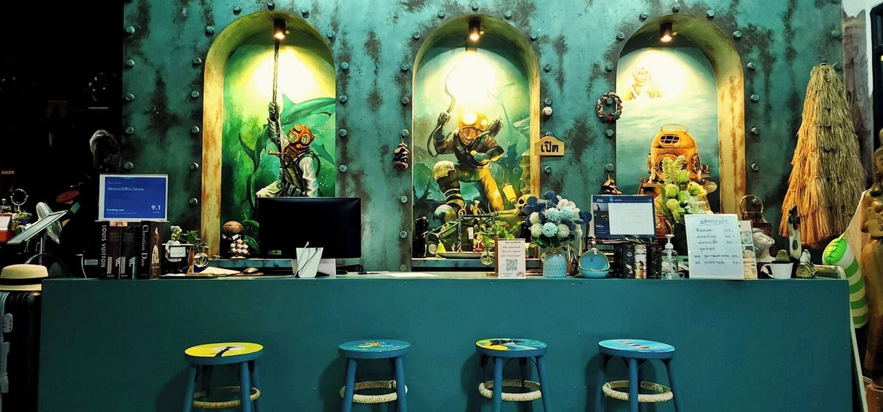 In-house cafe with deep-sea-diver wall murals and a teal counter