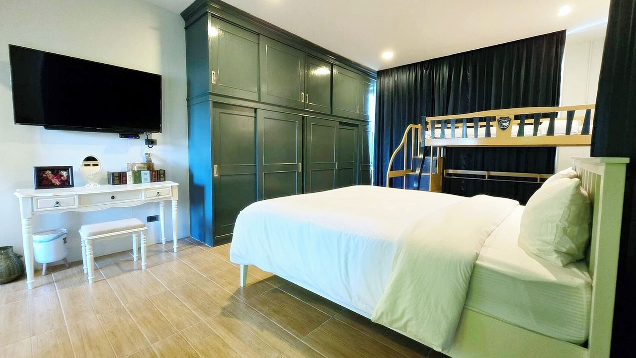Family bedroom with a double bed and bunk bed, dark green built-in wardrobe