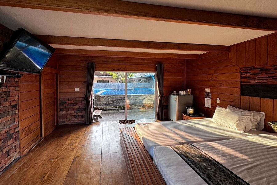 Timber cabin opening directly onto the swimming pool