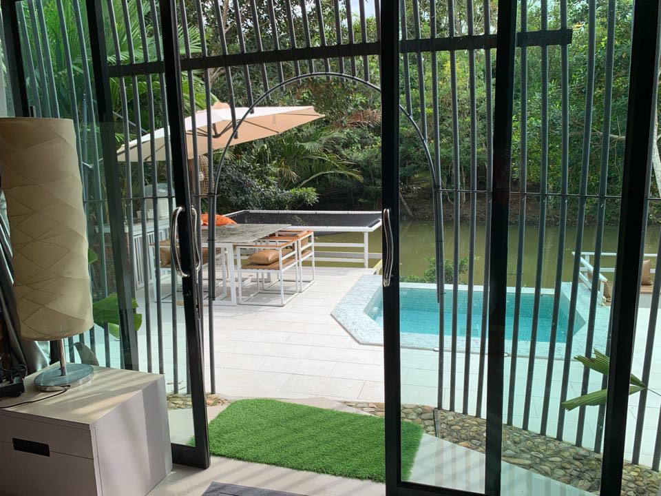 View from inside a villa out to the plunge pool and forested creek
