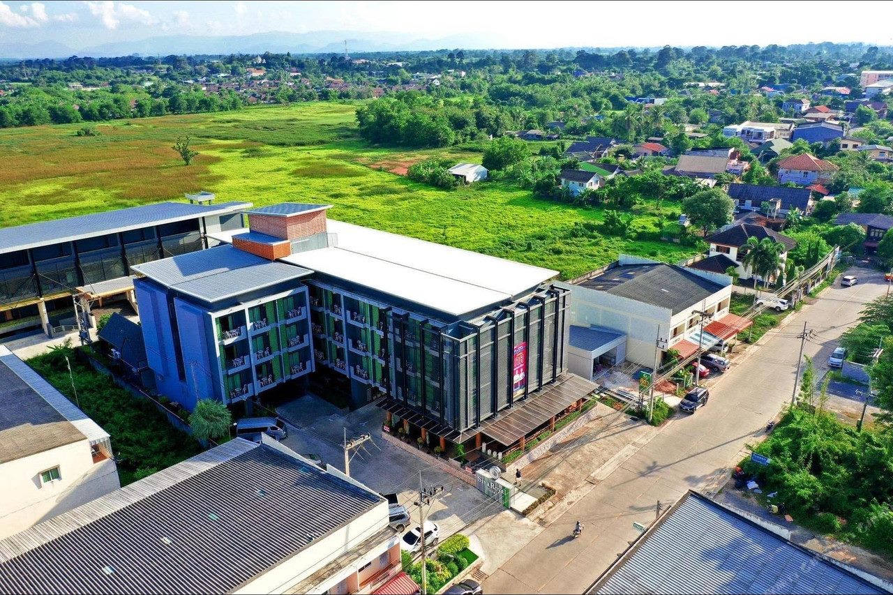 Aerial view of Siva Royal Hotel beside green paddy fields on the edge of Phatthalung town