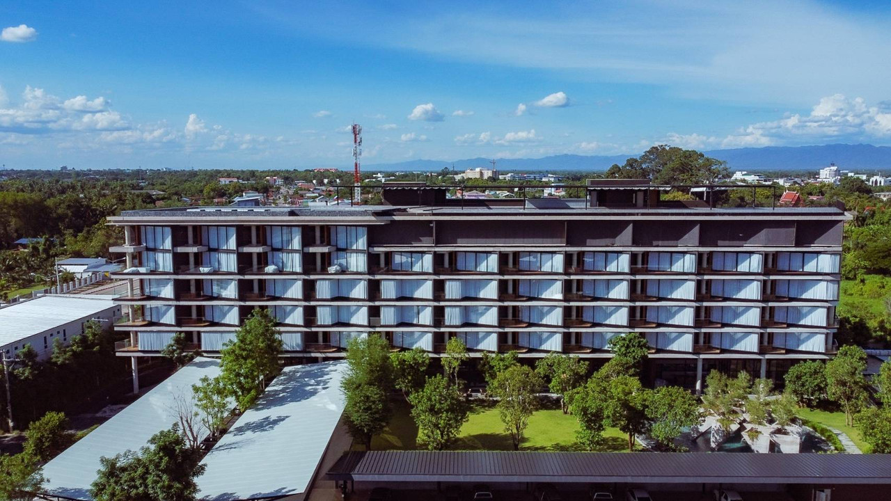Aerial view of the Livist Resort building with its pitched roof in central Phetchabun, mountains on the horizon
