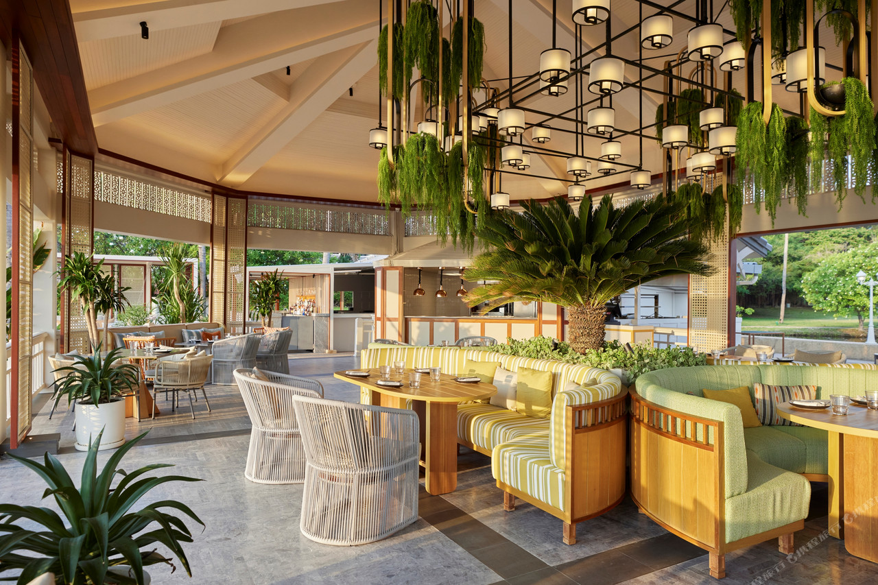 Open-air restaurant with plants and hanging pendant lights