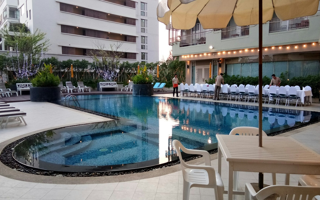 Courtyard swimming pool at Long Beach Cha-Am Hotel in the evening