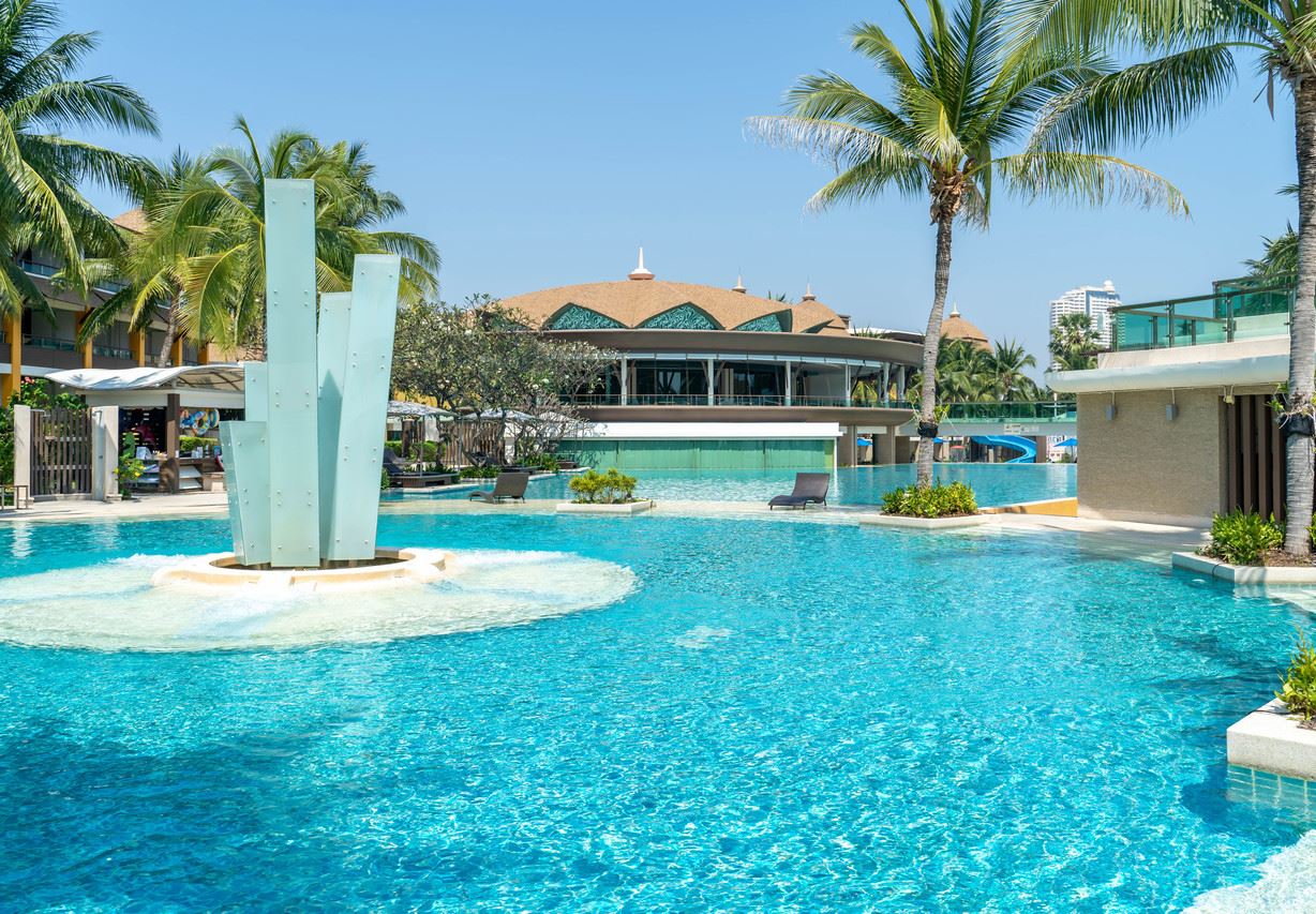 Lagoon pool with a sculptural fountain and Thai-roofed pavilion at Springfield @Sea