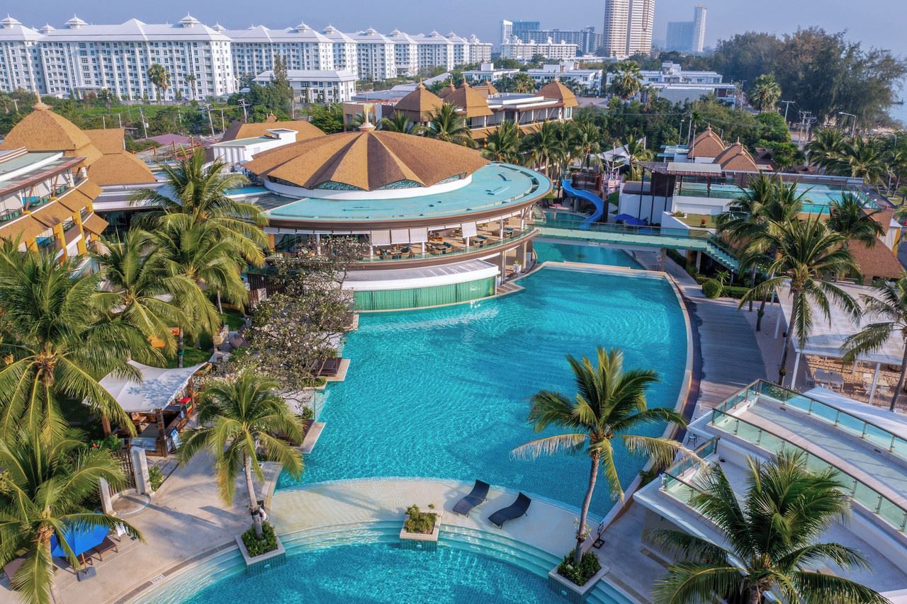 Aerial view of Springfield @Sea resort on Cha-am beach with multiple lagoon pools and palm gardens