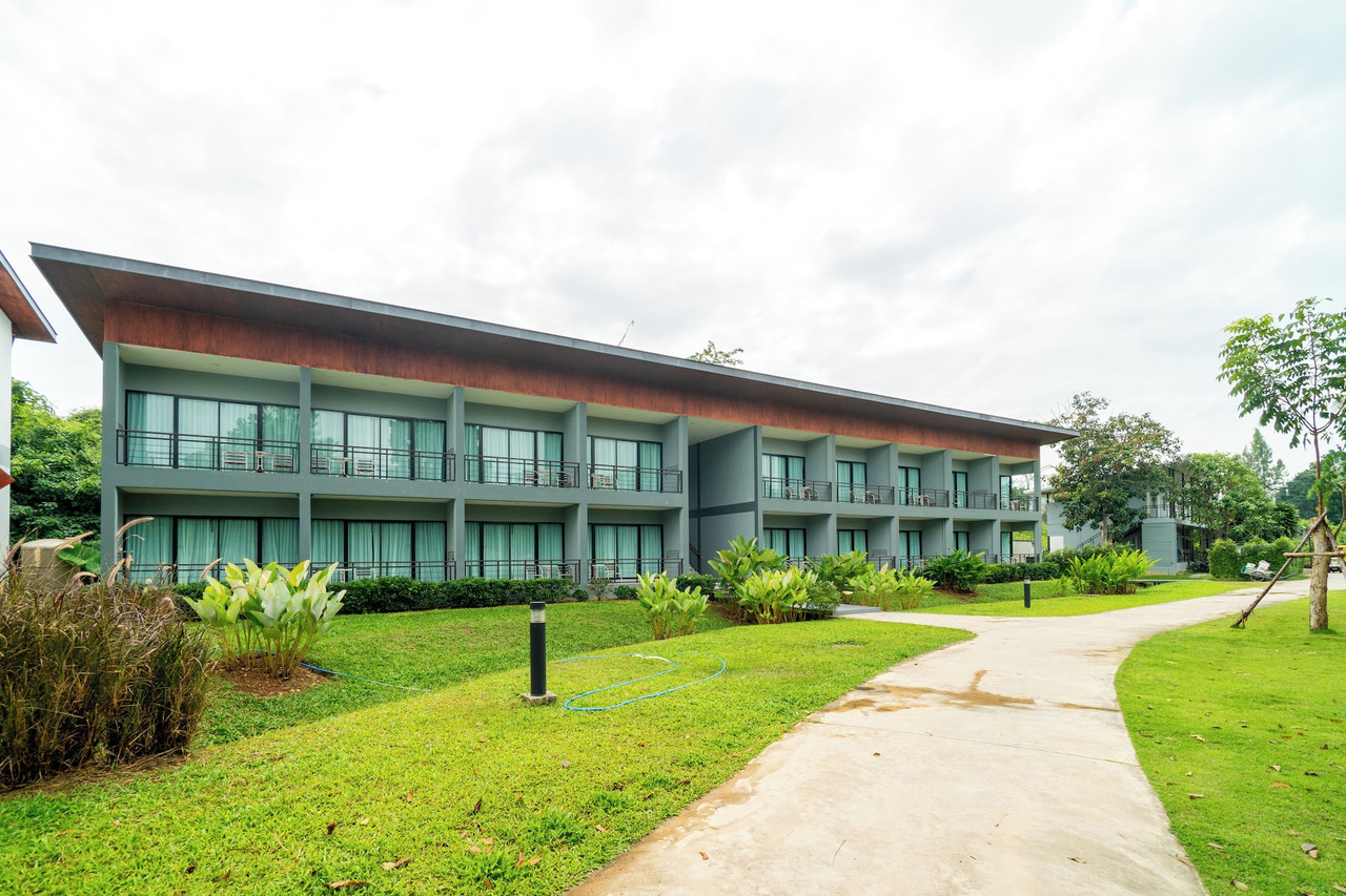 Two-storey Superior building with balconies on every room and a garden path