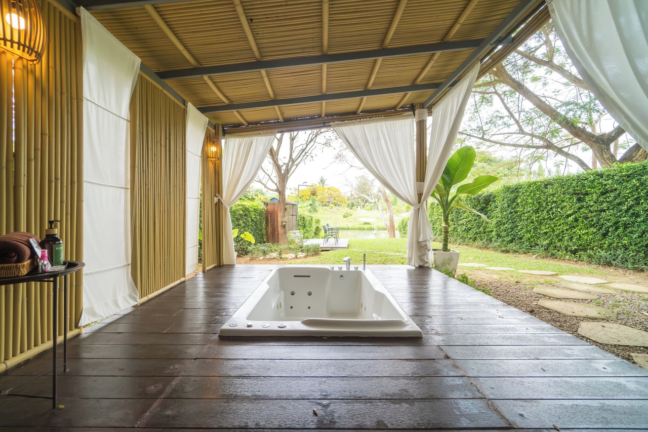 Outdoor jacuzzi at a Pool Villa looking out over the garden and river line