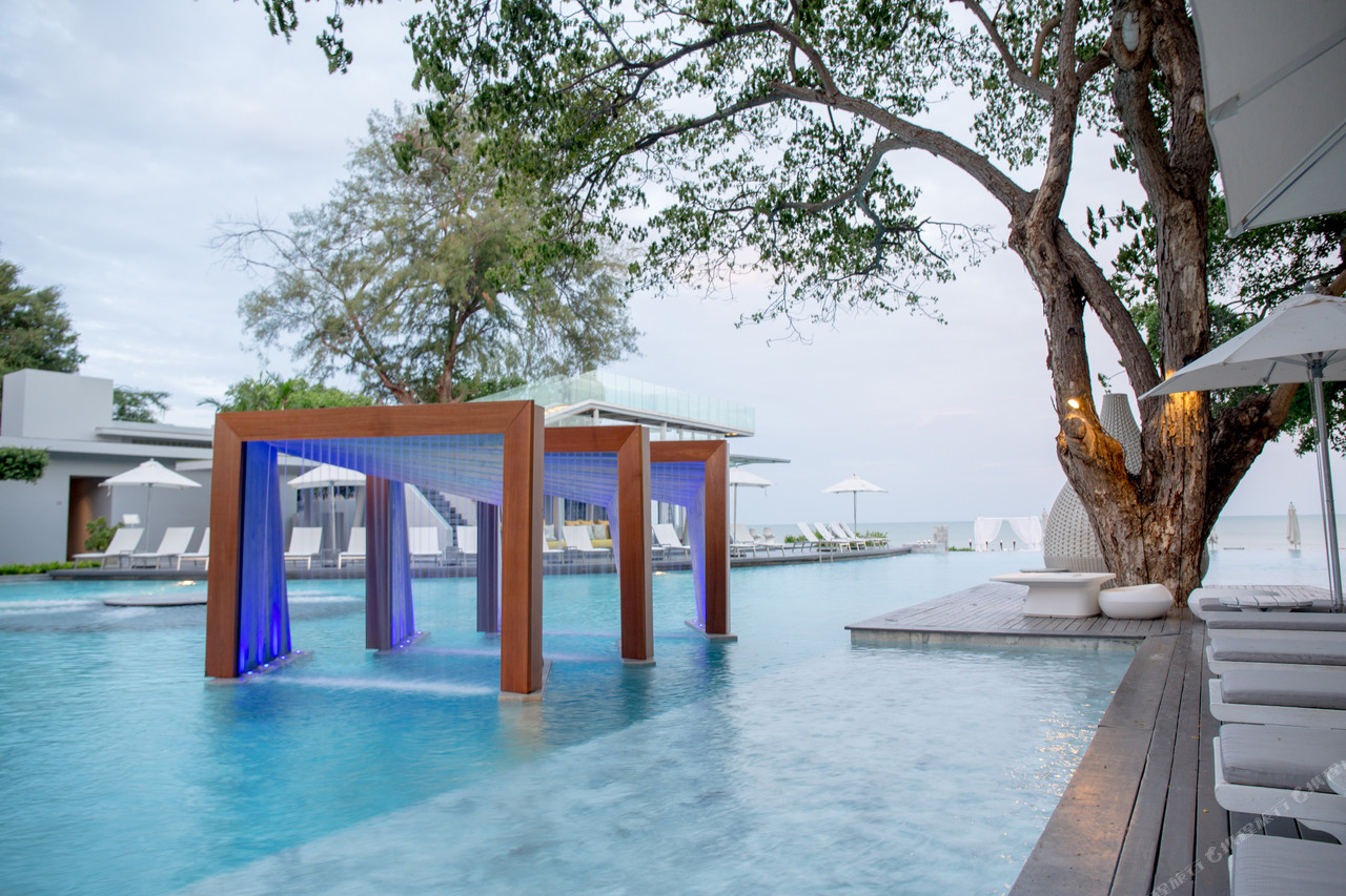 Sea-edge swimming pool with a blue-lit water cabana at Veranda Resort Cha-Am Hua Hin