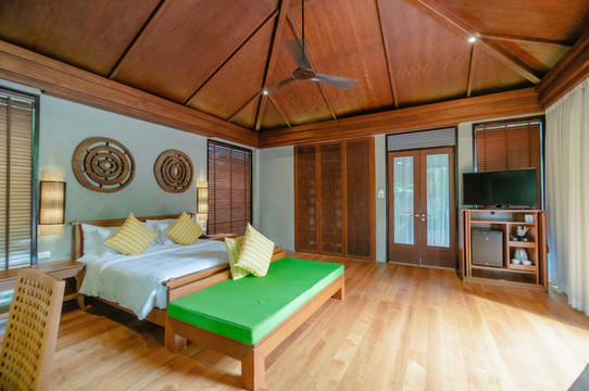Deluxe room with high pitched teak ceiling and a daybed