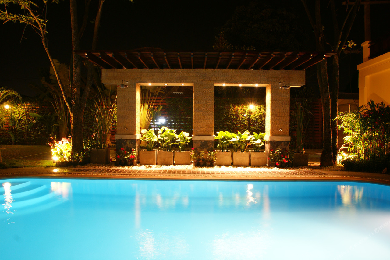 Swimming pool with a timber pavilion and garden planting