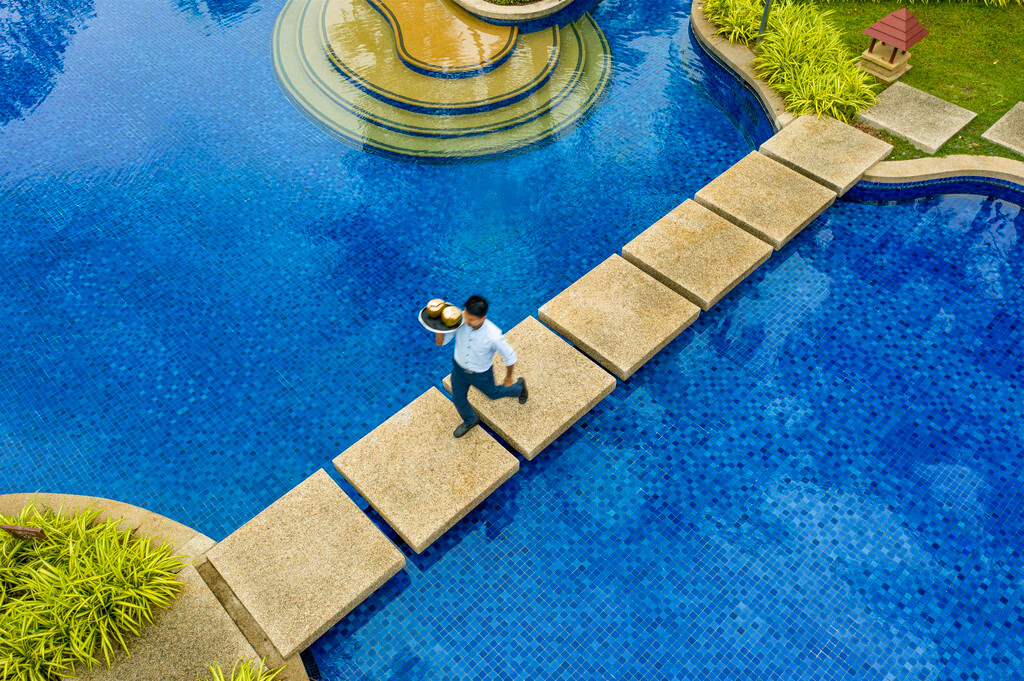 Bright blue lagoon-style pool with stepping stones at Banyan Tree Phuket